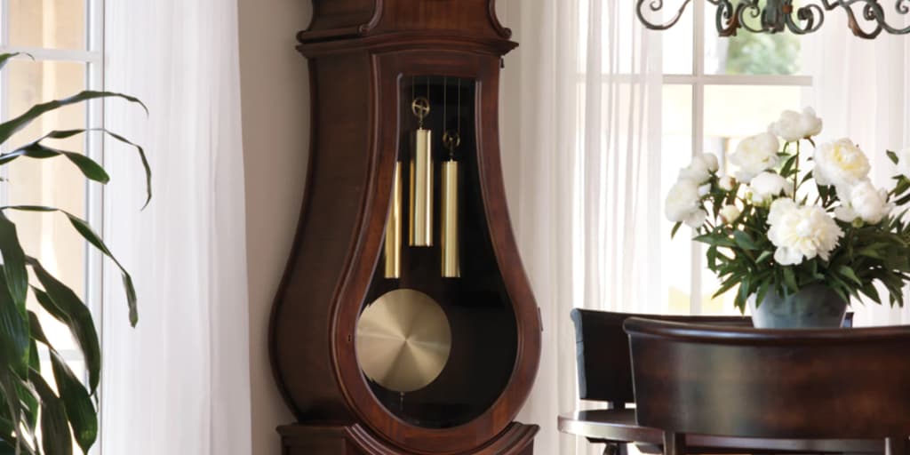 Vintage clock with golden weights near the wall