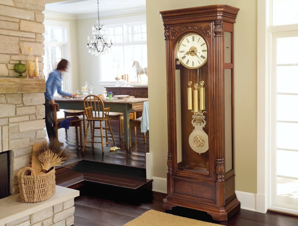 Vintage clock with golden weights near the wall