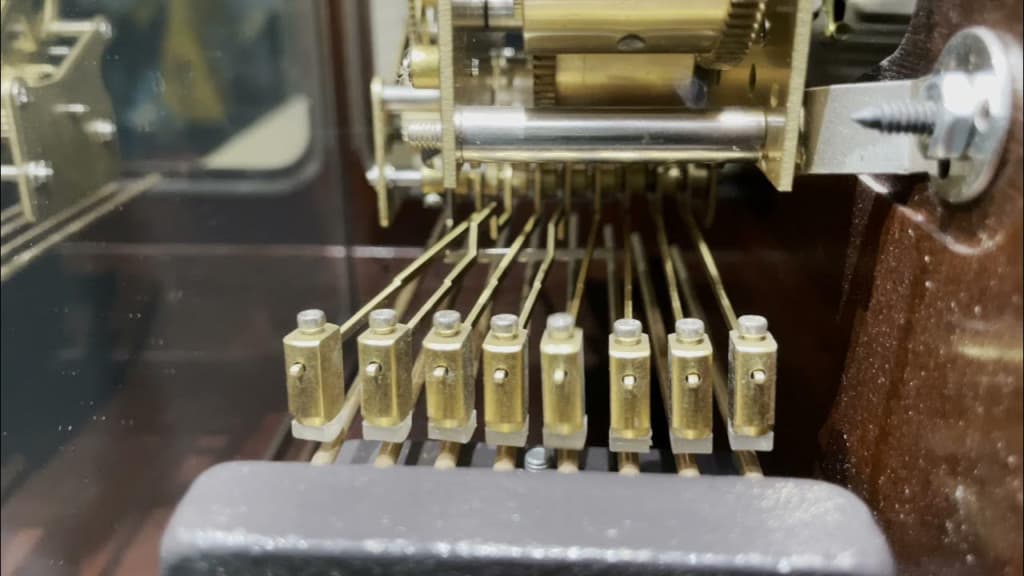 Vintage clock with golden weights near the wall